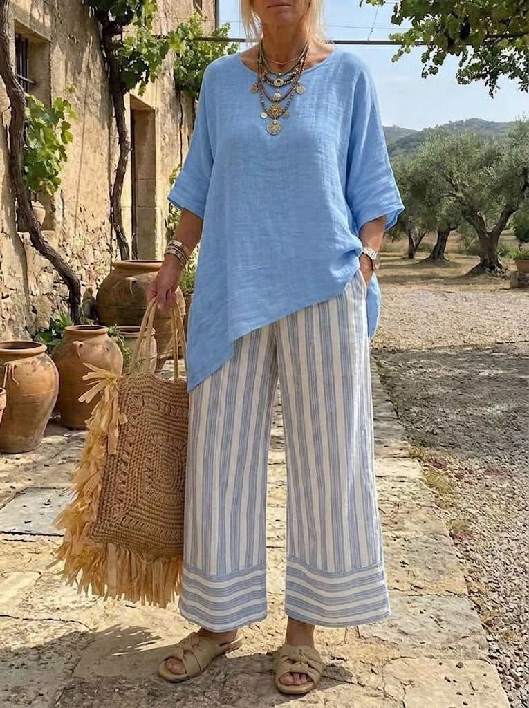 Completo donna con tunica asimmetrica blu e pantaloni a righe