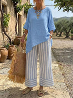Completo donna con tunica asimmetrica blu e pantaloni a righe